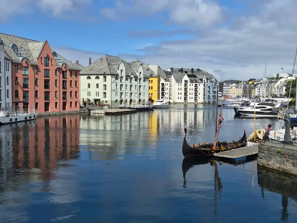 Colorful waterfront buildings reflected in still harbor