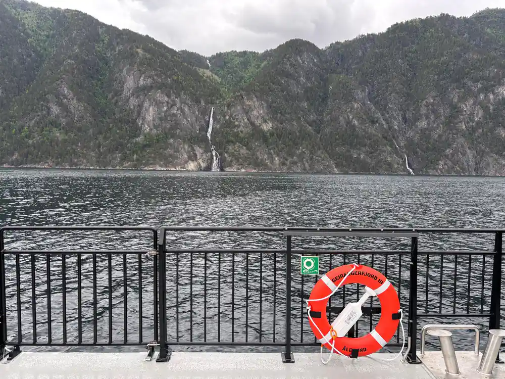 Deep fjord with high rocky cliffs and waterfall