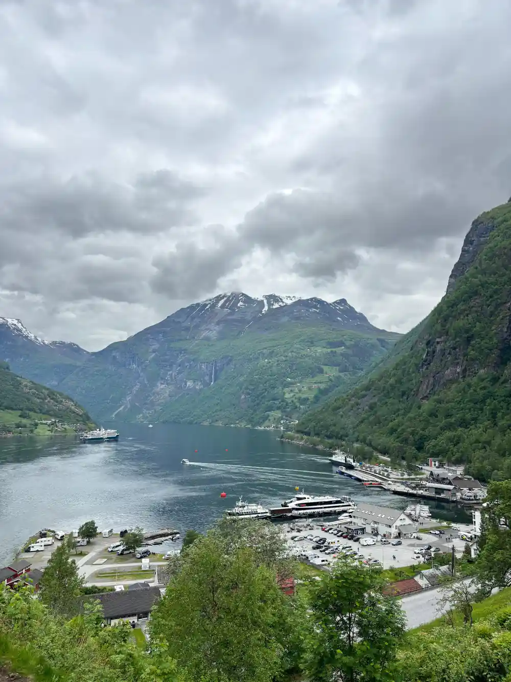 Fjord with steep mountains and cruise ship