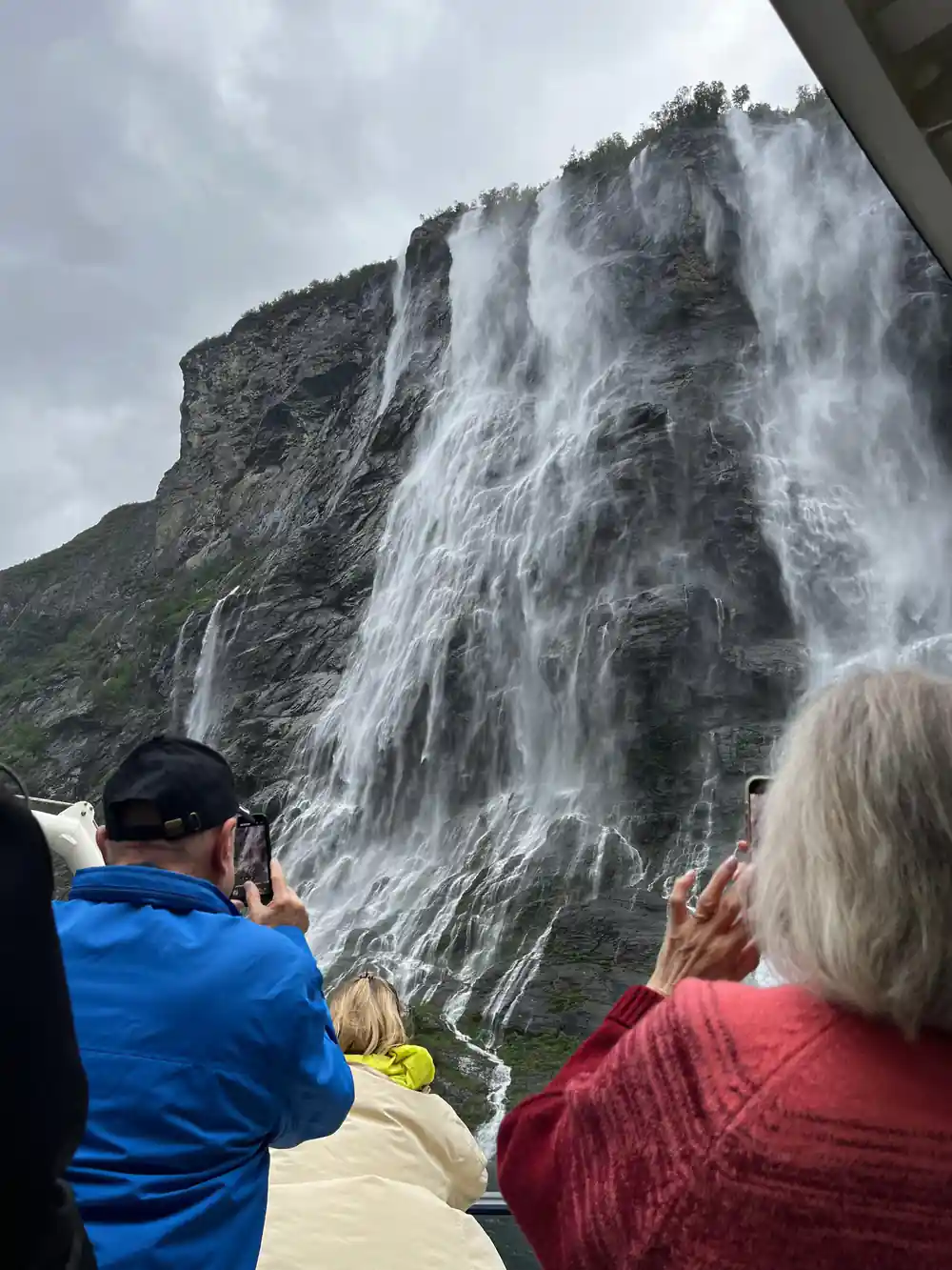 Multiple waterfalls cascading down rocky mountainside