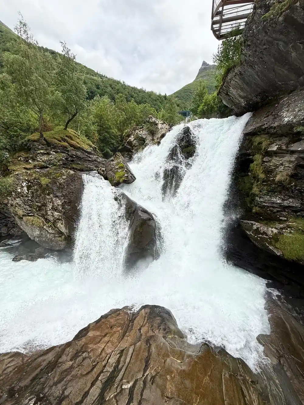 Powerful waterfall cascading over layered rock formations