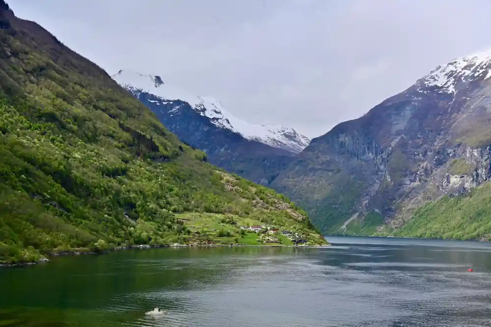 View from boat showing wake and green valley